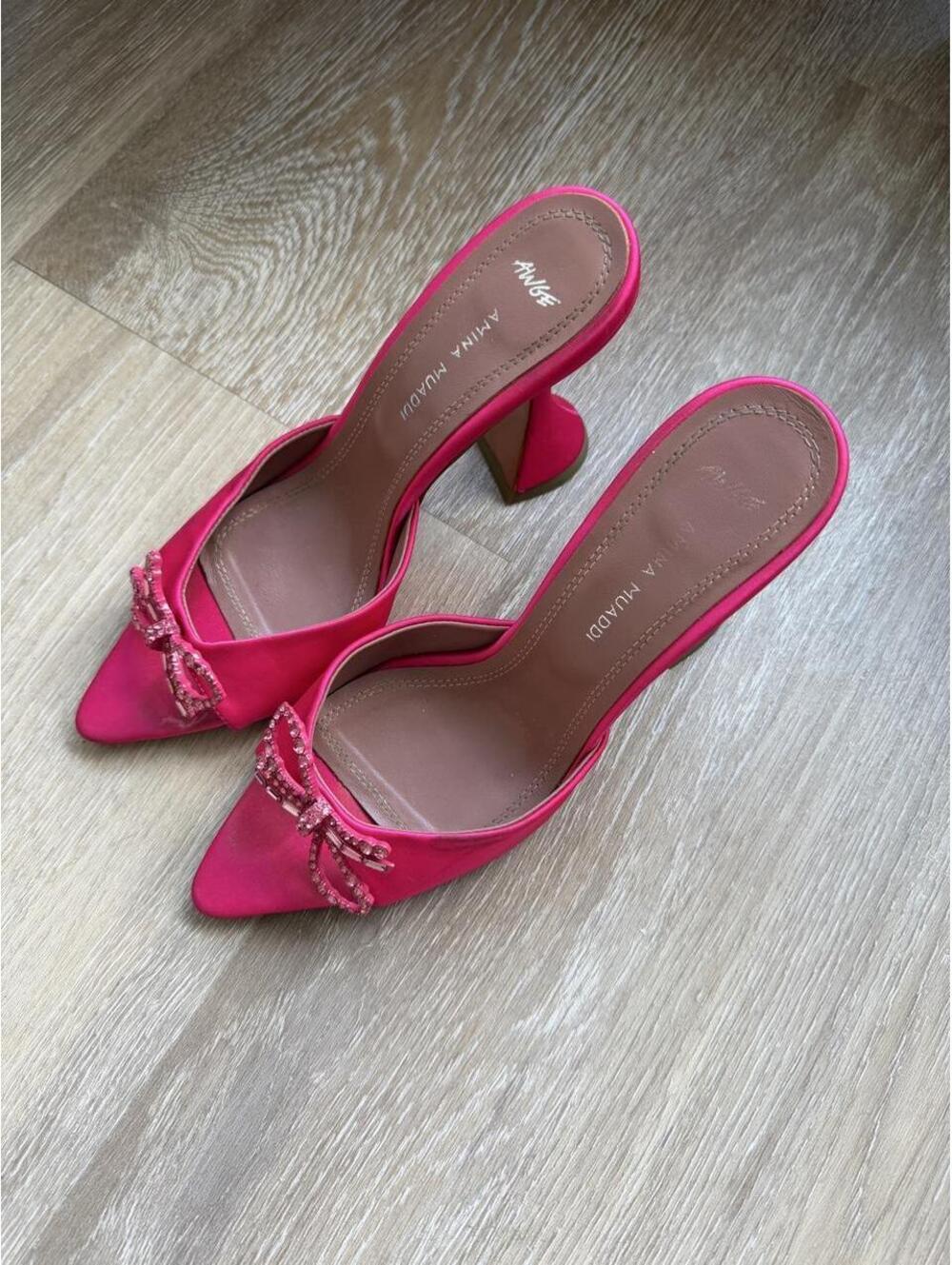 Amina Muaddi pink satin heels with rhinestone bow detail